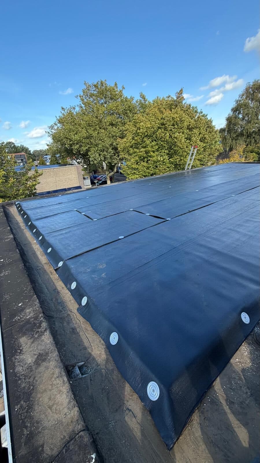 Strak afgewerkte dakrand van nieuwe bitumen dakbedekking